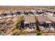 Aerial view of backyard with a covered patio, desert landscaping and a small seating area at 8142 S Open Trail Ln, Gold Canyon, AZ 85118