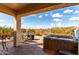 Covered patio with a hot tub overlooking a desert landscape with mountain views at 8142 S Open Trail Ln, Gold Canyon, AZ 85118