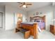 Bedroom with a wooden frame bed and a bench. There is a bathroom visible through the doors at 8142 S Open Trail Ln, Gold Canyon, AZ 85118