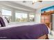 Bright bedroom with large windows, desert views, and a cozy purple and grey color scheme at 8142 S Open Trail Ln, Gold Canyon, AZ 85118