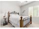 Bedroom with a white comforter on an iron bed frame with views from the window at 8142 S Open Trail Ln, Gold Canyon, AZ 85118