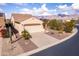 Charming single-story home with a two-car garage, desert landscaping, and a scenic mountain view at 8142 S Open Trail Ln, Gold Canyon, AZ 85118