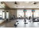 Bright fitness center with modern equipment, mirrored walls, and large windows for natural light and scenic views at 8142 S Open Trail Ln, Gold Canyon, AZ 85118