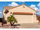 Beige stucco home featuring a wide garage, red clay roof tiles and a well kept yard at 8142 S Open Trail Ln, Gold Canyon, AZ 85118