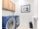 Laundry room with washer, dryer, cabinet and a picture on the wall at 8142 S Open Trail Ln, Gold Canyon, AZ 85118