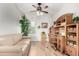 Office with a wooden desk set, tan couch, light-colored hardwood floors and a window at 8142 S Open Trail Ln, Gold Canyon, AZ 85118