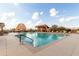 Relaxing outdoor swimming pool area complete with lounge seating, pergola, and a scenic desert landscape at 8142 S Open Trail Ln, Gold Canyon, AZ 85118