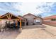 Spacious backyard featuring a wooden pergola, paver patio, and a volleyball net at 8204 W Tonto Ln, Peoria, AZ 85382