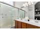 Bathroom features a double vanity, frosted glass shower, and modern fixtures at 8204 W Tonto Ln, Peoria, AZ 85382