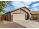 Front exterior of a desert home featuring a two-car garage and xeriscaping at 8204 W Tonto Ln, Peoria, AZ 85382