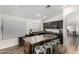 Kitchen featuring an island with seating, stainless steel appliances, and dark cabinetry at 8204 W Tonto Ln, Peoria, AZ 85382