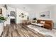 An open concept living room featuring a wood dining set and a comfortable leather sofa at 8204 W Tonto Ln, Peoria, AZ 85382