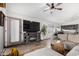 Open-concept living room with an entertainment center, wood flooring, and views to the kitchen at 8204 W Tonto Ln, Peoria, AZ 85382