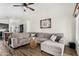 Spacious living room featuring a sectional sofa with wood flooring at 8204 W Tonto Ln, Peoria, AZ 85382