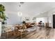 Open-concept living room featuring hardwood floors, stylish furniture, and a modern light fixture at 8204 W Tonto Ln, Peoria, AZ 85382