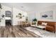 An open concept living room featuring a wood dining set and a comfortable leather sofa at 8204 W Tonto Ln, Peoria, AZ 85382