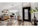 Bright home office with wood floors, modern furniture, shelving, and an ornate glass front door at 8204 W Tonto Ln, Peoria, AZ 85382