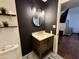 Modern bathroom showcasing a stylish vanity, elegant fixtures, and a striking accent wall at 8410 N 32Nd Ave, Phoenix, AZ 85051