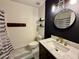 Stylish bathroom featuring a modern vanity, round mirror, and elegant fixtures at 8410 N 32Nd Ave, Phoenix, AZ 85051