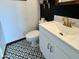 Charming powder room with black and white patterned tile floor, a modern vanity and stylish decor at 8410 N 32Nd Ave, Phoenix, AZ 85051