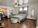 Spacious bedroom features wood floors, a ceiling fan, and a vanity at 8410 N 32Nd Ave, Phoenix, AZ 85051