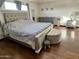 Spacious bedroom features wood floors, a bed with tufted headboard, and vanity at 8410 N 32Nd Ave, Phoenix, AZ 85051