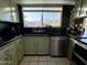 Efficient kitchen space with stainless steel dishwasher and oven, bright light and dark countertops at 8410 N 32Nd Ave, Phoenix, AZ 85051