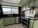 Functional kitchen space with stainless steel appliances, plentiful natural light and stylish backsplash at 8410 N 32Nd Ave, Phoenix, AZ 85051