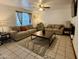 Inviting living room featuring tile floors, neutral-toned sofas, decorative pillows, and a modern coffee table at 8410 N 32Nd Ave, Phoenix, AZ 85051