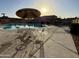 Community pool with seating area under shade, perfect for relaxing and enjoying the outdoors on a sunny day at 8410 N 32Nd Ave, Phoenix, AZ 85051