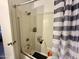 Standard shower with a rod and gray and white striped curtain at 8410 N 32Nd Ave, Phoenix, AZ 85051