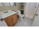 Bathroom with a single-sink vanity and shower with built-in shelves at 8815 W Columbus Ave, Phoenix, AZ 85037