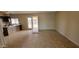 Open-concept space showcasing tile floors, a sliding glass door, and a glimpse of the adjacent kitchen area at 8815 W Columbus Ave, Phoenix, AZ 85037