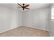 Neutral bedroom features a ceiling fan and bright windows with blinds at 934 E Cochise Dr, Phoenix, AZ 85020