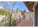 Private outdoor space featuring table seating for two on a red brick patio with mature landscaping at 934 E Cochise Dr, Phoenix, AZ 85020