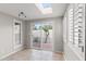 Bright sunroom with tile floors, skylight, and sliding glass doors to an outdoor courtyard at 934 E Cochise Dr, Phoenix, AZ 85020