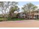 Basketball court with a hoop, and residential houses with green grass in the background at 964 S Henry Ln, Gilbert, AZ 85296