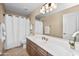 This clean bathroom features a shower, vanity, large mirror, and neutral decor at 964 S Henry Ln, Gilbert, AZ 85296