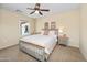 This bedroom features a ceiling fan, large window and neutral decor at 964 S Henry Ln, Gilbert, AZ 85296