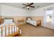 This bright ' bedroom features two twin beds with matching bedding, a ceiling fan, and a window at 964 S Henry Ln, Gilbert, AZ 85296