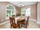 Traditional dining room with a wooden table, six chairs, and a large arched window providing ample natural light at 964 S Henry Ln, Gilbert, AZ 85296