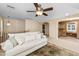 Upstairs living room featuring a comfortable sofa, ceiling fan, and views of the adjacent office space at 964 S Henry Ln, Gilbert, AZ 85296