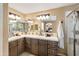 This bathroom features double sinks with granite countertops, decorative wallpaper, and a walk-in shower at 964 S Henry Ln, Gilbert, AZ 85296