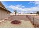 Spacious backyard with decorative rock landscaping, a palm tree, and block fence perimeter at 9703 W Forrester Dr, Sun City, AZ 85351