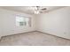 Bedroom featuring neutral carpet, a ceiling fan and a window at 9703 W Forrester Dr, Sun City, AZ 85351