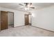 Bedroom with plush carpeting and access to a large walk-in closet at 9703 W Forrester Dr, Sun City, AZ 85351