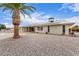 Rear exterior with solar panels, desert landscaping, and a covered patio at 9703 W Forrester Dr, Sun City, AZ 85351