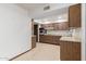 Spacious kitchen with white walls and wood cabinets at 9703 W Forrester Dr, Sun City, AZ 85351