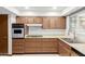 Kitchen featuring wood cabinets, laminate countertops, and stainless steel appliances at 9703 W Forrester Dr, Sun City, AZ 85351