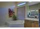 Elegant bathroom featuring a garden tub, stylish fixtures, and natural light at 9785 E Preserve Way, Scottsdale, AZ 85262